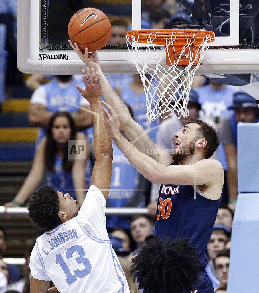 Gerry Broome North Carolina's Cameron Johnson (13) defends while Virginia's Jay Huff (30) shoots during the first half of an NCAA college basketball game in Chapel Hill, N.C., Monday, Feb. 11, 2019. (AP Photo/Gerry Broome)