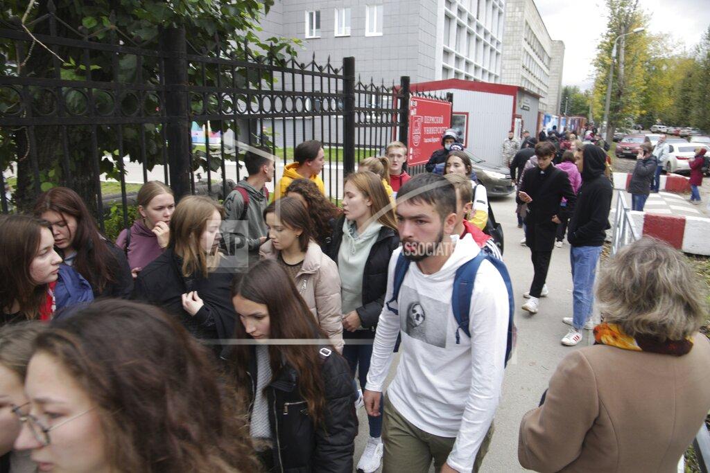 Anastasia Yakovleva A group of students gather near the Perm State University in Perm, about 1,100 kilometers (700 miles) east of Moscow, Russia, Monday, Sept. 20, 2021. A gunman opened fire in a university in the Russian city of Perm on Monday morning, leaving at least eight people dead and others wounded, according to Russia's Investigative Committee. (AP Photo/Anastasia Yakovleva)