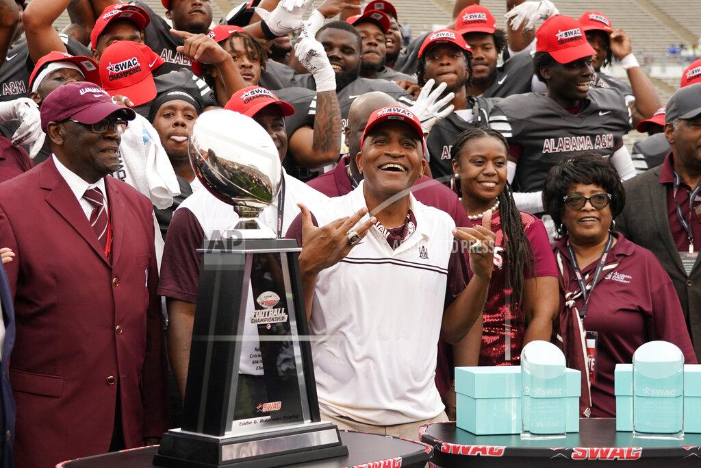 Rogelio V. Solis Alabama A&M coach Connell Maynor and the team await being given the Southwestern Athletic Conference championship trophy following an NCAA college football game against Arkansas-Pine Bluff, Saturday, May 1, 2021, in Jackson, Miss. Alabama A&M won 40-33. (AP Photo/Rogelio V. Solis)