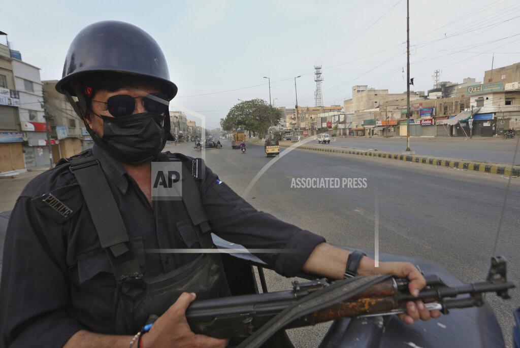 Fareed Khan A police officer take position on a vehicle at a deserted road due to strikes called by the the country's religious political parties over the security forces's crackdown against a banned Tehreek-e-Labaik Pakistan party, in Karachi, Pakistan, Monday, April 19, 2021. An outlawed Pakistani Islamist political group freed 11 policemen almost a day after taking them hostage in the eastern city of Lahore amid violent clashes with security forces, the country's interior minister said Monday. (AP Photo/Fareed Khan)