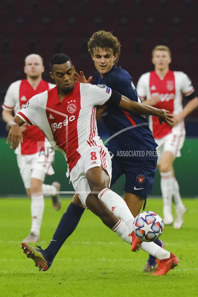 Patrick Post Ajax's Ryan Gravenberch, left, and Midtjylland's Nicolas Madsen vie for the ball during the group D Champions League soccer match between Ajax and Midtjylland at the Johan Cruyff ArenA in Amsterdam, Netherlands, Wednesday, Nov. 25, 2020. (AP Photo/Patrick Post)