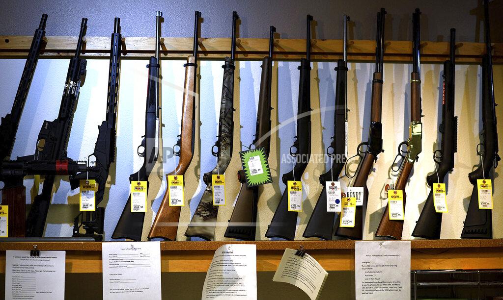 Kathy Plonka FILE - In this March 28, 2020, file photo, rifles are offered for sale at Center Target Sports in Post Falls, Idaho. After a year of pandemic lockdowns, mass shootings are back, but the guns never went away. As the U.S. inches toward a post-pandemic future, guns are arguably more present in the American psyche and more deeply embedded in American discourse than ever before. The past year's anxiety and loss fueled a rise in gun ownership across political and socio-economic lines. (Kathy Plonka/The Spokesman-Review via AP, File)