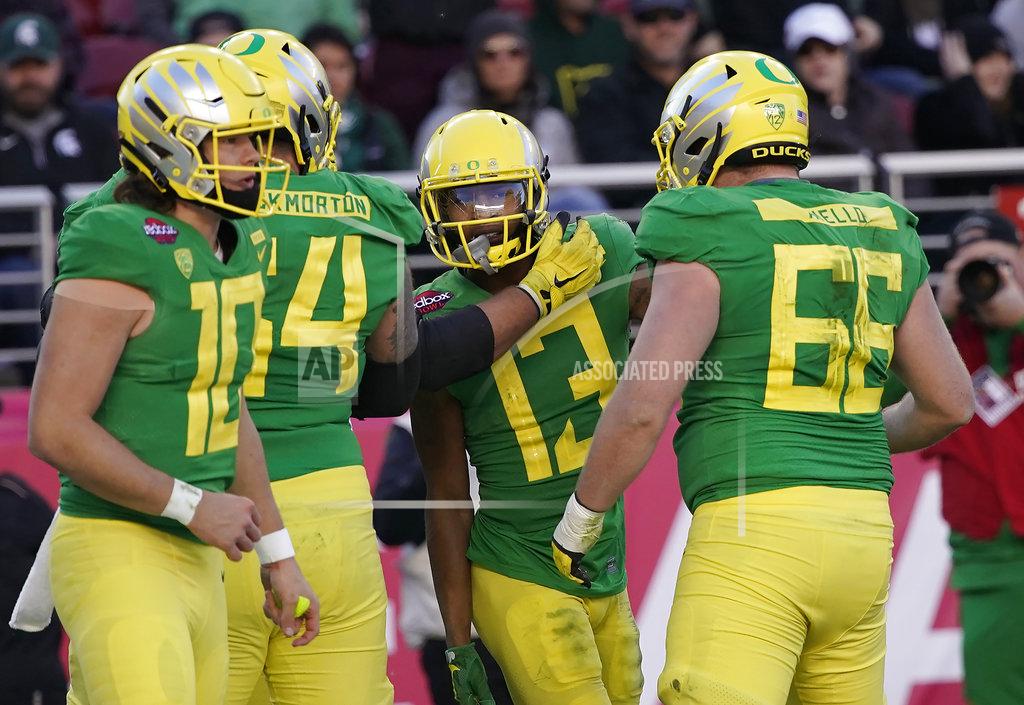 Tony Avelar Oregon wide receiver Dillon Mitchell (13) celebrates with Brady Aiello (66) and Calvin Throckmorton (54) after scoring a touchdown against Michigan State during the second half of the Redbox Bowl NCAA college football game Monday, Dec. 31, 2018, in Santa Clara, Calif. Oregon won 7-6. (AP Photo/Tony Avelar)