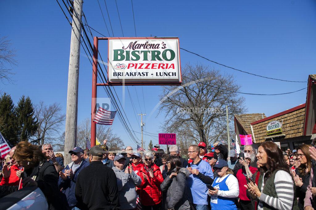 Nicole Hester Hundreds of people gather in front of on Marlena's Bistro in Holland in support of the owner Marlena Pavlos-Hackney on Saturday March 20, 2021. (Nicole Hester/Mlive.com/Ann Arbor News via AP)
