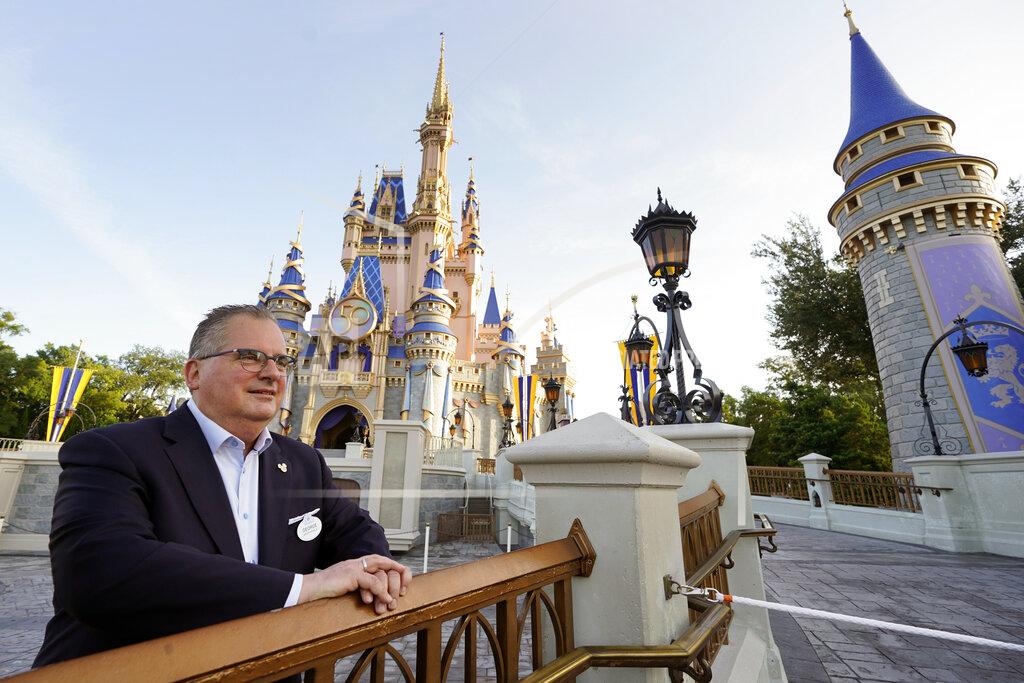 John Raoux George Kalogridis, president of segment development and enrichment for Disney Parks, stands in front of the Cinderella Castle at the Magic Kingdom theme park at Walt Disney World Monday, Aug. 30, 2021, in Lake Buena Vista, Fla. Kalogridis was one of 6,000 employees that was working at the theme park on opening day in 1971. (AP Photo/John Raoux)