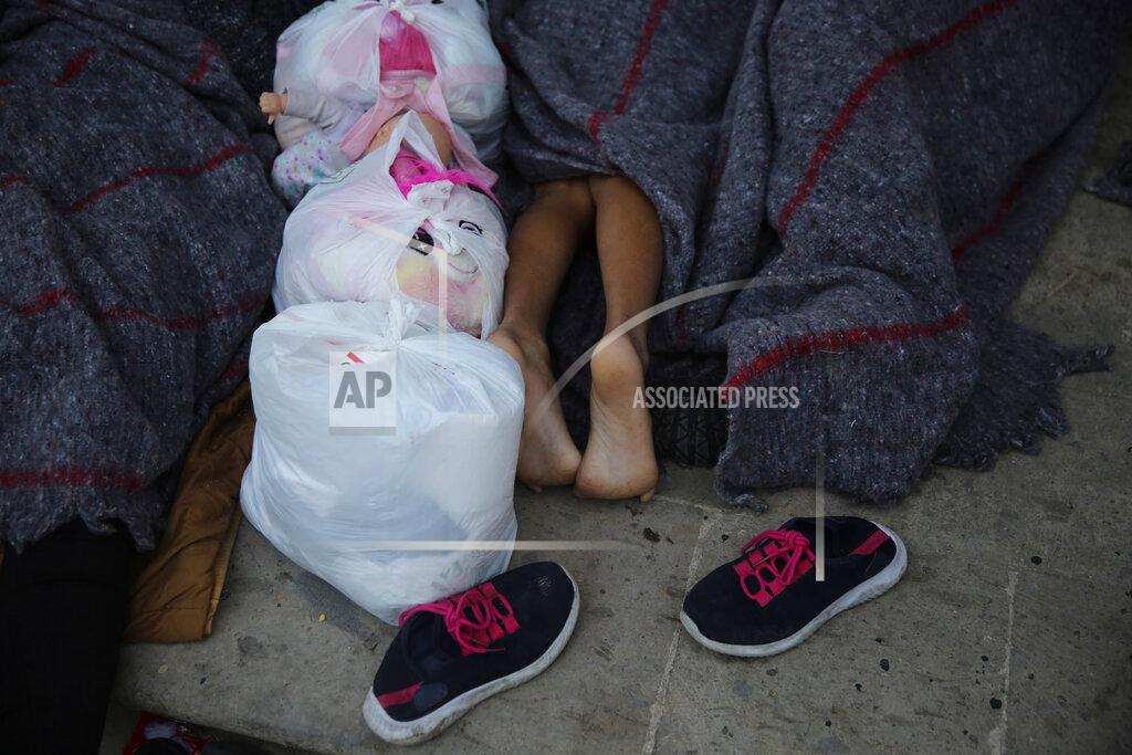 A child sleeps under a gazebo at a park in the Mexican border city of Reynosa, Saturday, March 27, 2021. Dozens of migrants who earlier tried to cross into the U.S. in order to seek asylum have turned this park into an encampment for those expelled from the U.S. under pandemic-related presidential authority. (AP Photo/Dario Lopez-Mills)
