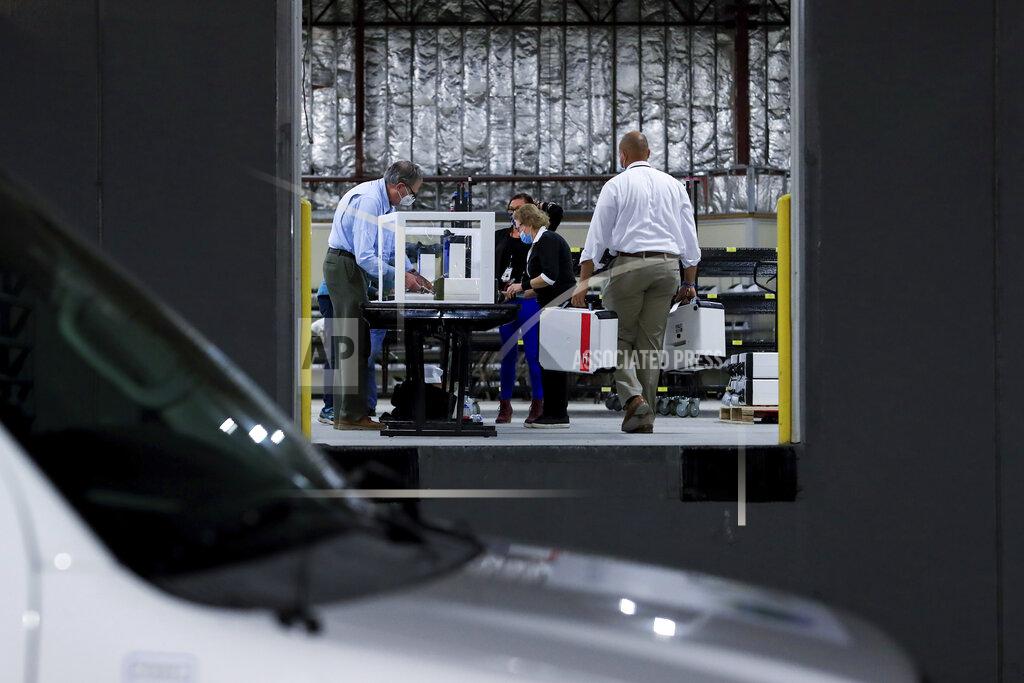 Aaron Doster A Hamilton County election department employees handle ballot boxes from delivery trucks during the general elections at the Hamilton County Board of Elections, Tuesday, Nov. 3, 2020, in Norwood, Ohio. (AP Photo/Aaron Doster)
