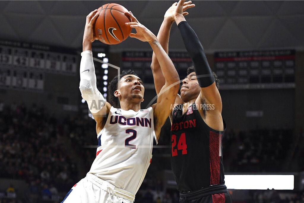 Jessica Hill Connecticut's James Bouknight (2) shoots as Houston's Quentin Grimes (24) defends in the first half of an NCAA college basketball game, Thursday, March 5, 2020, in Storrs, Conn. (AP Photo/Jessica Hill)