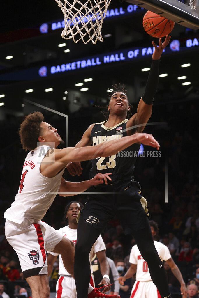 Jason Decrow CORRECTS TO OVERTIME, NOT SECOND HALF - Purdue's Jaden Ivey (23) goes to the basket against North Carolina State's Jericole Hellems (4) during the overtime period of their NCAA college basketball game Sunday, Dec. 12, 2021, in New York. (AP Photo/Jason DeCrow)