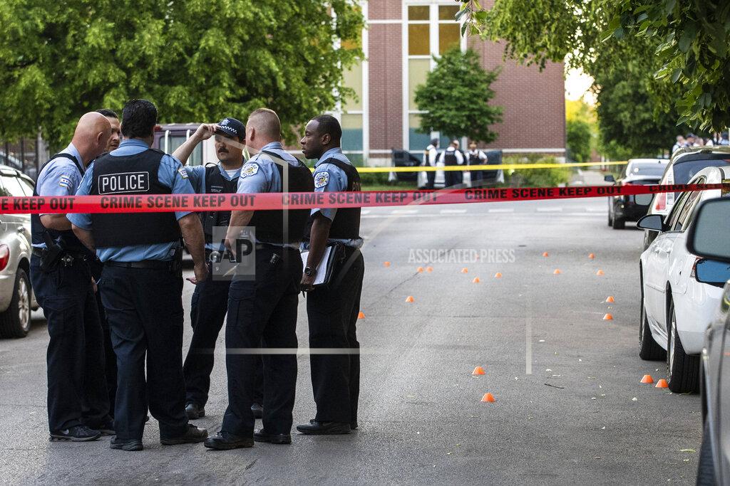 Ashlee Rezin Garcia Chicago police investigate in the 700 block of North Spaulding Avenue, where a 40-year-old man was shot multiple times while he was riding in a car on the West Side on Memorial Day, Monday night, May 31, 2021, in Chicago. (Ashlee Rezin Garcia/Sun-Times/Chicago Sun-Times via AP)
