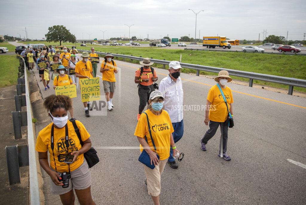 Ricardo B. Brazziell People walk along the service road of Interstate Highway 35, in Georgetown, Texas to participate in a Selma-style march for democracy from Georgetown, Texas to the Texas State Capitol in downtown Austin. On Wednesday, July 28, 2021 the group made a stop at Good Hope church in Round Rock and will end with a rally at the Capitol at 10 am on July 31st. Church leaders and former Democratic congressman Beto O'Rourke are leading a nearly 30-mile voting rights march in Texas.(Ricardo B. Brazziell/Austin American-Statesman via AP)