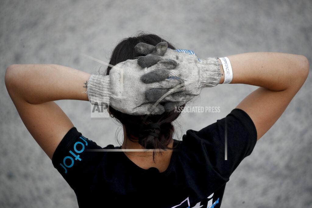 Natacha Pisarenko Vitarti Girl’s Team mechanic Agustina Carreira watches from the pits as her team competes in its first-ever race at the Oscar y Juan Galvez track in Buenos Aires, Argentina, Sunday, April 4, 2021. “The only place in my career where I did not face prejudice was in this race,” she said. (AP Photo/Natacha Pisarenko)