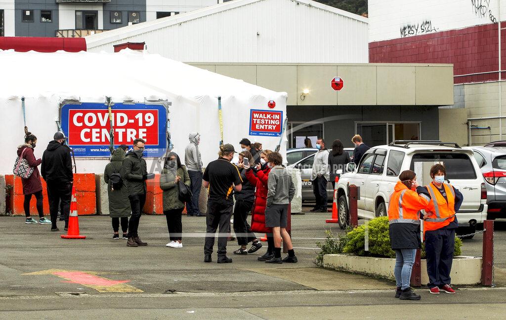 Jack Crossland People queue outside a COVID-19 testing station in central Wellington, New Zealand, Wednesday, June, 23, 2021. After enjoying nearly four months without any community transmission of the coronavirus, New Zealanders were on edge Wednesday after health authorities said an infectious traveler from Australia had visited over the weekend. (Jack Crossland/NZ Herald via AP)