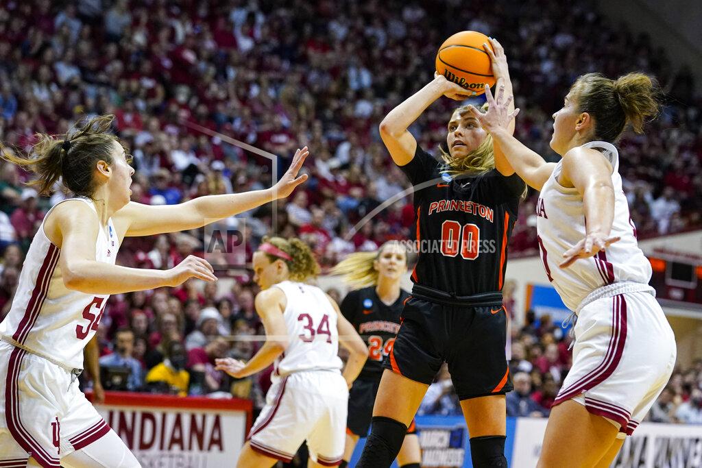 Michael Conroy Princeton forward Ellie Mitchell (00) shoots between Indiana forward Mackenzie Holmes (54) and forward Aleksa Gulbe (10) in the first half of a college basketball game in the second round of the NCAA tournament in Bloomington, Ind., Monday, March 21, 2022. (AP Photo/Michael Conroy)
