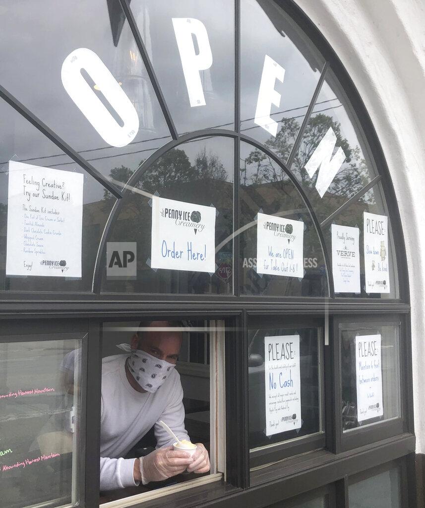 Martha Mendoza Zachary Davis, poses for a photo at The Penny Ice Creamery in Santa Cruz, Calif. Friday, April 17, 2020. Davis who owns two ice cream parlors, a beachside cafe and a taco bar in Santa Cruz, has had to lay off 70 employees due to the coronavirus outbreak. (AP Photo/Martha Mendoza)