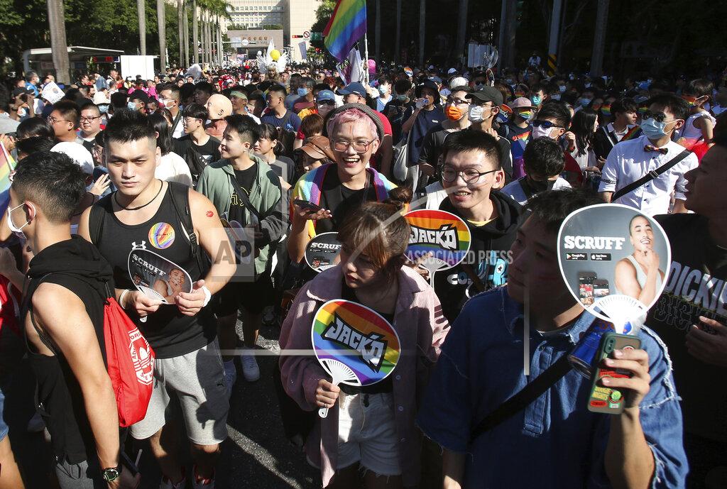 Chiang Ying-Ying Participants march through a street during a pride parade in Taipei, Taiwan, Saturday, Oct. 31, 2020. (AP Photo/Chiang Ying-ying)