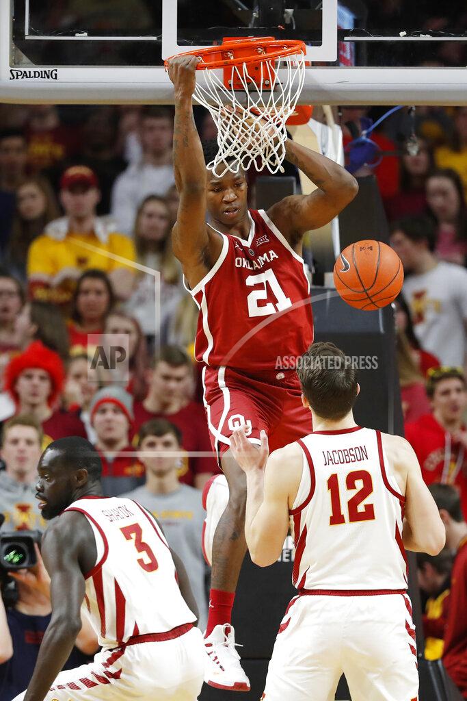 Charlie Neibergall Oklahoma forward Kristian Doolittle (21) dunks the ball over Iowa State's Marial Shayok (3) and Michael Jacobson (12) during the second half of an NCAA college basketball game, Monday, Feb. 25, 2019, in Ames, Iowa. (AP Photo/Charlie Neibergall)