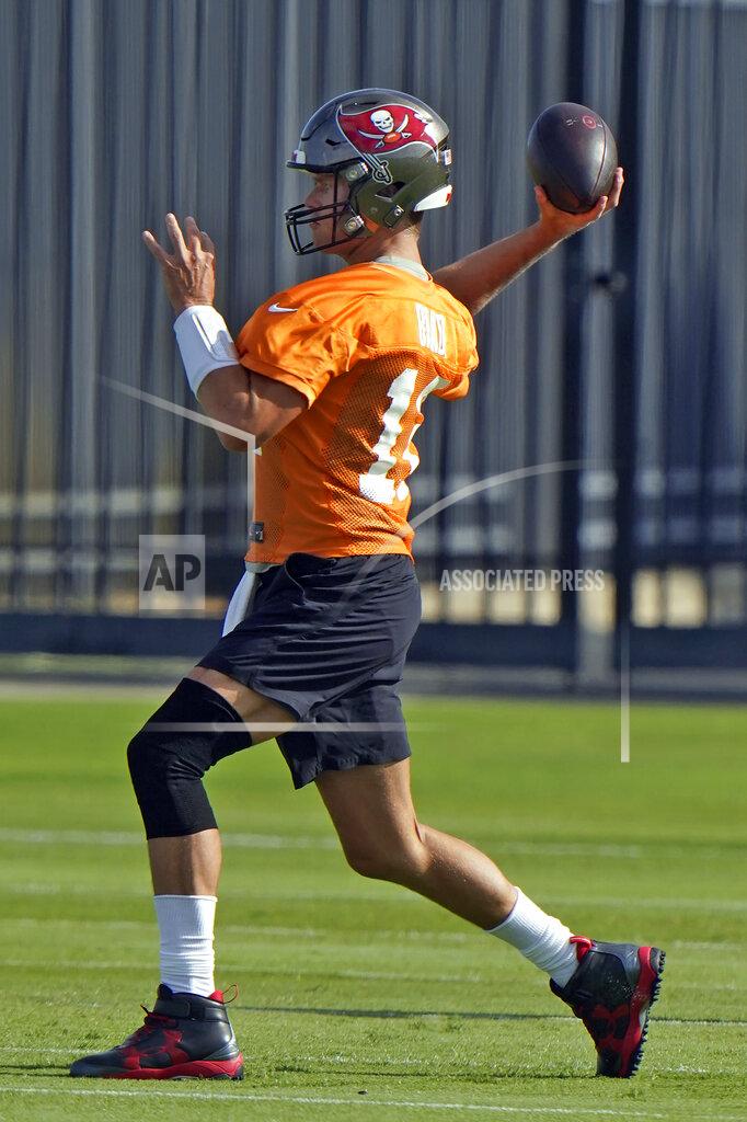 Tampa Bay Buccaneers quarterback Tom Brady wears a knee brace as he throws a pass during an NFL football minicamp Tuesday, June 8, 2021, in Tampa, Fla. (AP Photo/Chris O'Meara)