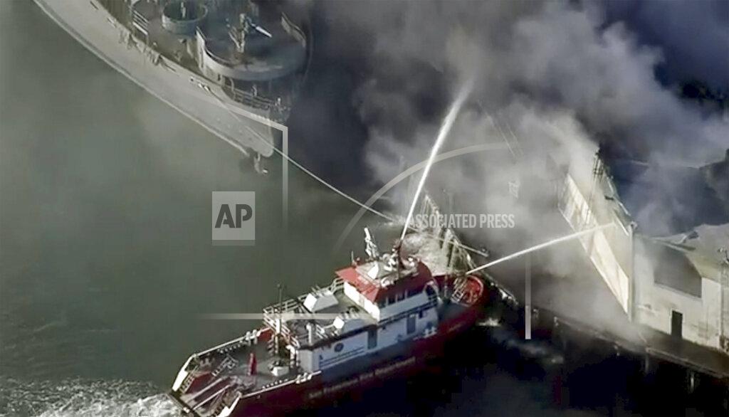 First responders battle a massive fire that erupted at a warehouse early Saturday, May 23, 2020 in San Francisco. Arriving crews were confronted with towering flames engulfing the warehouse. (KPIX-TV CBS-Viacom via AP)