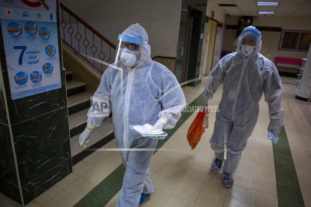 Khalil Hamra Palestinian medics wear protective suits as they take part in a simulation of possible coronavirus infections in Gaza City, Saturday, July 18, 2020. (AP Photo/Khalil Hamra)