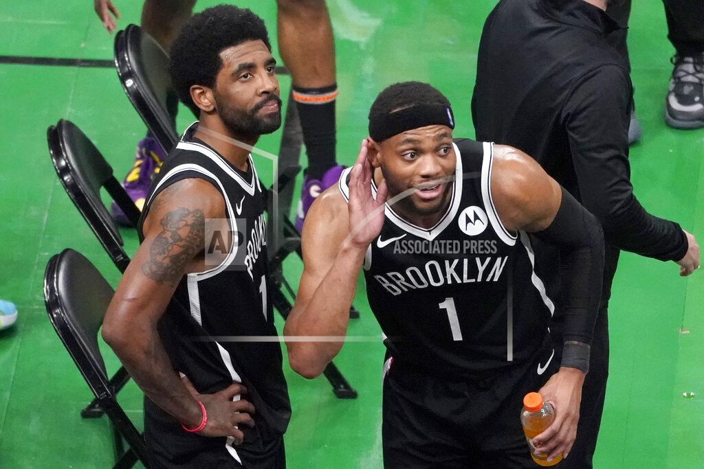 Elise Amendola Brooklyn Nets guard Kyrie Irving, left, looks up at the fans at TD Garden while teammate Bruce Brown (1) gestures after they defeated the Boston Celtics in Game 4 during an NBA basketball first-round playoff series, Sunday, May 30, 2021, in Boston. Irving was booed and heckled by the fans all game. (AP Photo/Elise Amendola)