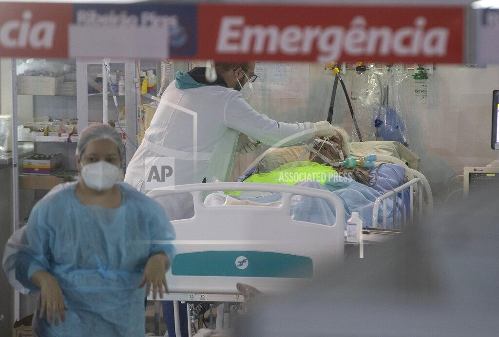 Andre Penner Health workers treat a COVID-19 patient at the emergency unit of a field hospital set up to treat COVID patients in Ribeirao Pires, greater Sao Paulo area, Brazil, Tuesday, April 13, 2021. (AP Photo/Andre Penner)