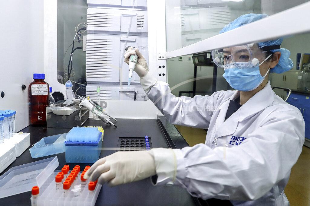 Zhang Yuwei In this April 11, 2020, photo released by Xinhua News Agency, a staff member tests samples of a potential COVID-19 vaccine at a production plant of SinoPharm in Beijing. In the global race to make a coronavirus vaccine, the state-owned Chinese company is boasting that it gave its employees, including top executives, experimental shots even before the government OK'd testing in people. (Zhang Yuwei/Xinhua via AP)
