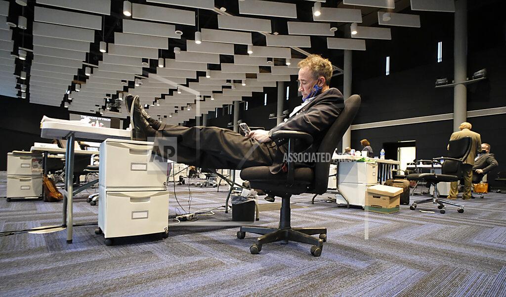 Bob Brown Sen. Joe Morrissey, D-Richmond, relaxes and reads texts during a recess of the floor session of the Virginia Senate, which is meeting inside the Science Museum of Virginia in Richmond, Va., Saturday, Feb. 27, 2021. (Bob Brown/Richmond Times-Dispatch via AP)