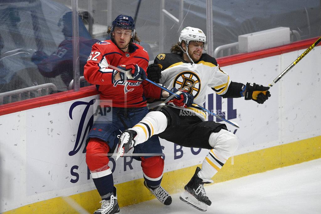 Nick Wass Washington Capitals left wing Carl Hagelin (62) and Boston Bruins right wing David Pastrnak (88) collide along the boards during the second period of an NHL hockey game, Monday, Feb. 1, 2021, in Washington. (AP Photo/Nick Wass)