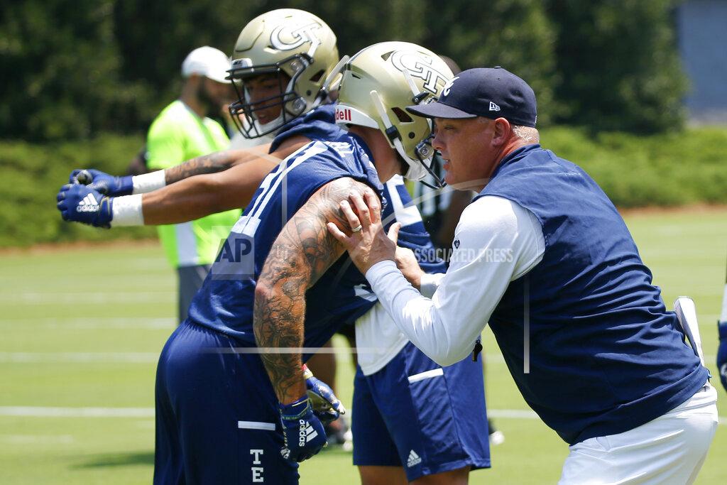 John Bazemore Georgia Tech head coach Geoff Collins works with his players during the team's first preseason NCAA college football practice Wednesday, July 31, 2019, in Atlanta. (AP Photo/John Bazemore)