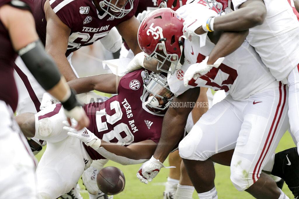 Sam Craft Texas A&M running back Isaiah Spiller (28) has the ball stripped away from him by Alabama linebacker Shane Lee (35) for a turnover during the first half of an NCAA college football game, Saturday, Oct. 12, 2019, in College Station, Texas. (AP Photo/Sam Craft)