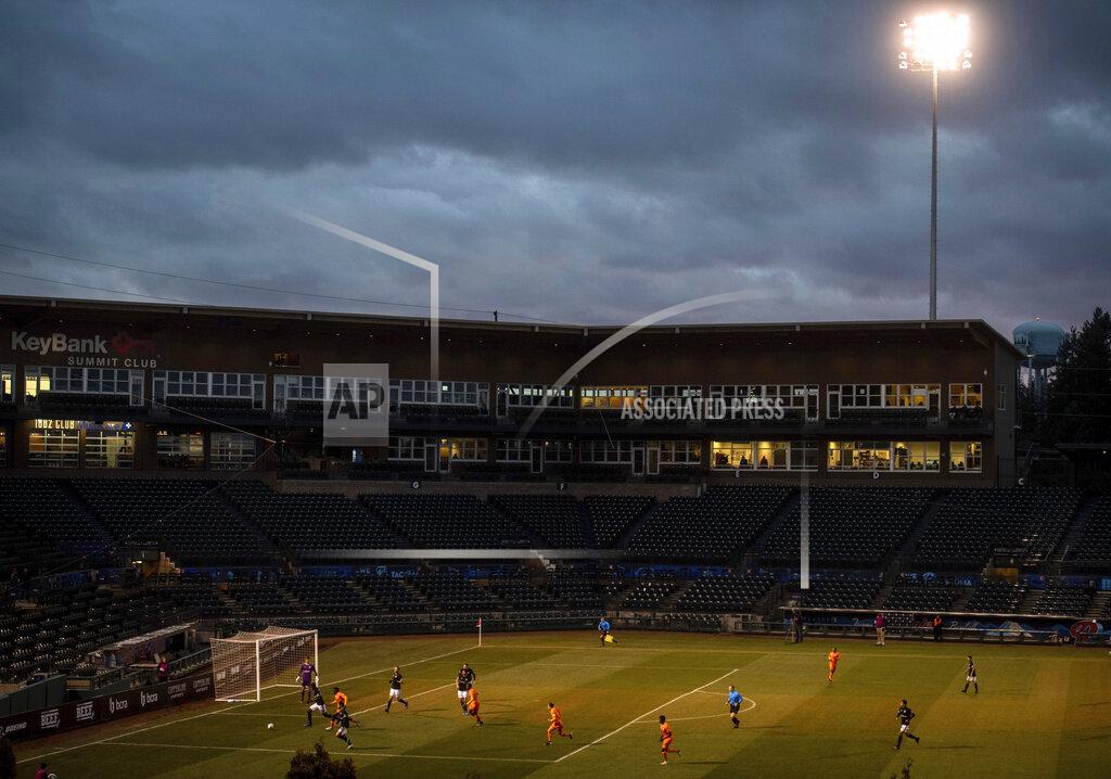 Joshua Bessex FILE - In this March 11, 2020, file photo, the Tacoma Defiance, a United Soccer League team based in Tacoma, Wash., play the San Diego Royal in a USL match inside an empty Cheney Stadium in Tacoma, Wash. Unlike the NFL, NBA or Major League Baseball that can run on television revenue, it's impossible for some minor sports leagues in North America to go on in empty stadiums and arenas in light of the coronavirus pandemic. (Joshua Bessex/The News Tribune via AP, File)