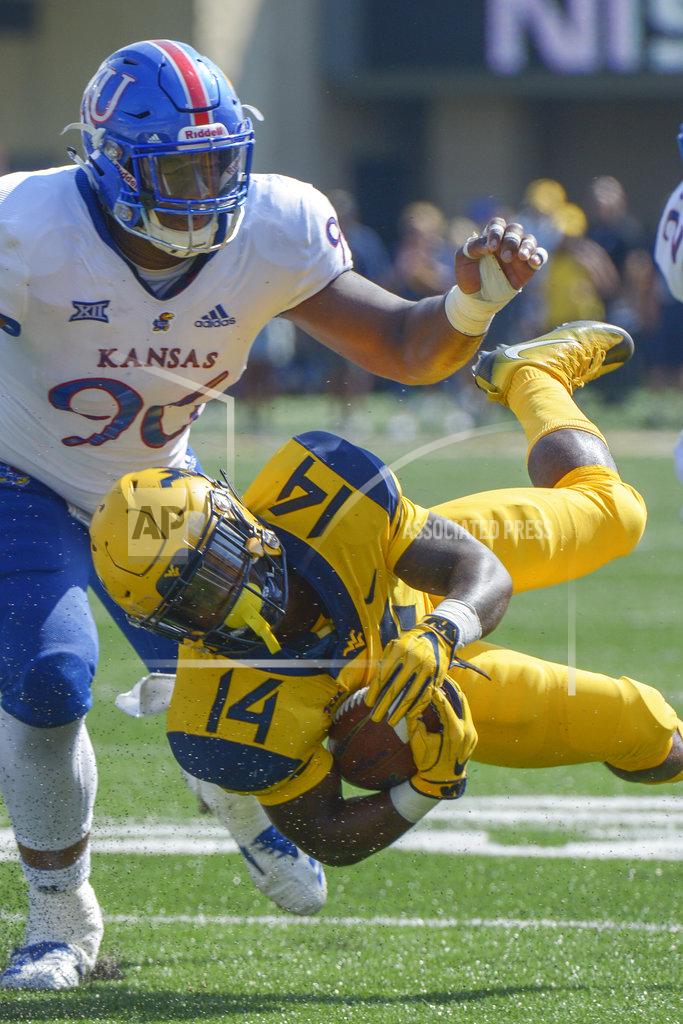 Craig Hudson West Virginia running back Tevin Bush (14) dives for yardage during an NCAA college football game against Kansas in Morgantown, W. Va., Saturday Oct. 6, 2018. (AP Photo/Craig Hudson)