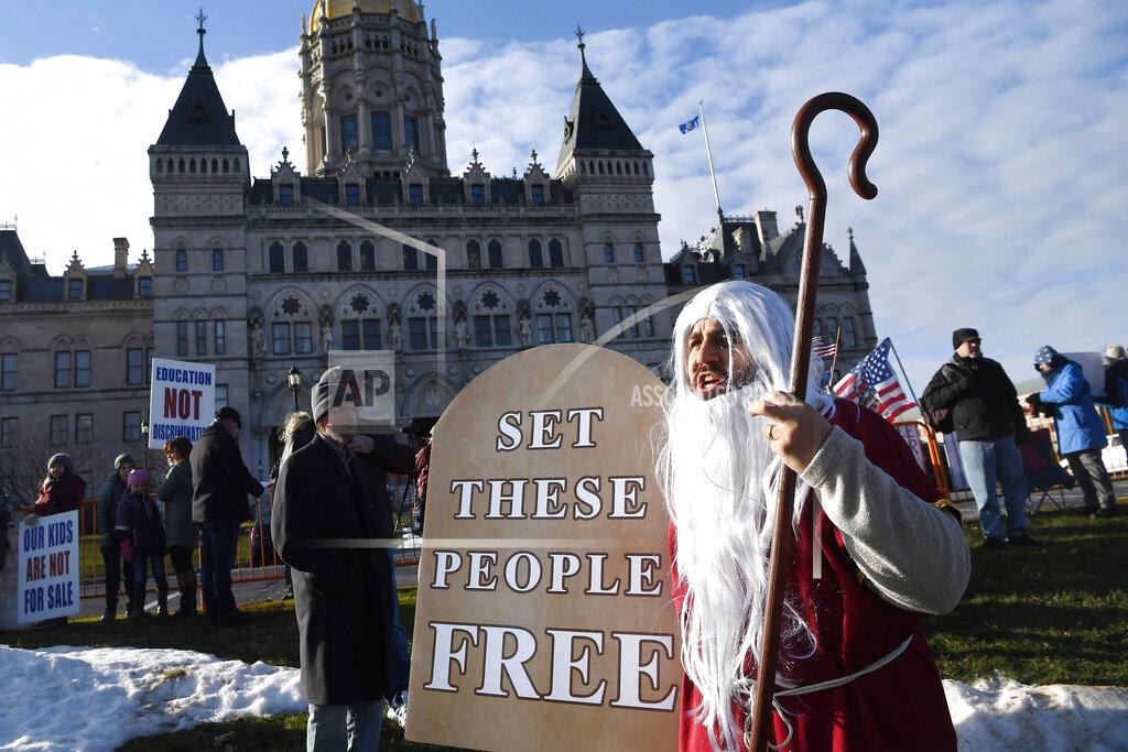 Jessica Hill Jonathan Johnson of New Britain protests outside on the State Capitol grounds, Wednesday, Jan. 6, 2021, in Hartford, Conn. Hundreds of protesters turned out for the swearing-in ceremonies. (AP Photo/Jessica Hill)