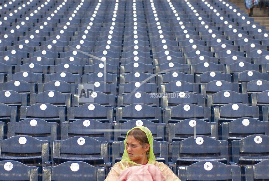Laurence Kesterson A fan waits out a rain delay after the second inning of a baseball game between the Philadelphia Phillies and the Washington Nationals, Sunday, Sept. 11, 2022, in Philadelphia. (AP Photo/Laurence Kesterson)