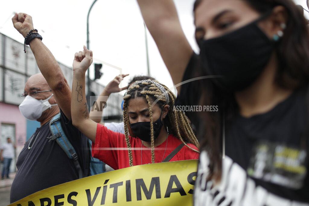 Silvia Izquierdo Activists protest the day after a deadly police operation in the Jacarezinho favela of Rio de Janeiro, Brazil, Friday, May 7, 2021. A bloody, hours-long gunbattle here echoed into Friday, with authorities saying the police mission killed two dozen criminals while residents and activists claimed human rights abuses. (AP Photo/Silvia Izquierdo)