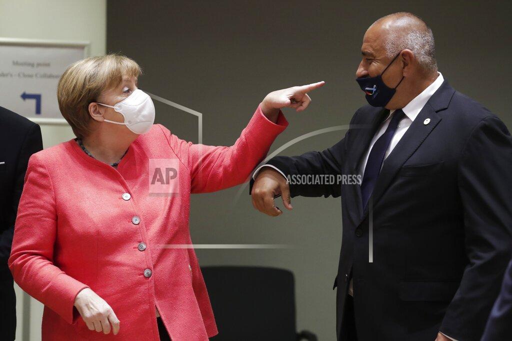 Stephanie Lecocq German Chancellor Angela Merkel, left, speaks with Bulgaria's Prime Minister Boyko Borissov during a round table meeting at an EU summit in Brussels, Friday, July 17, 2020. Leaders from 27 European Union nations meet face-to-face on Friday for the first time since February, despite the dangers of the coronavirus pandemic, to assess an overall budget and recovery package spread over seven years estimated at some 1.75 trillion to 1.85 trillion euros. (Stephanie Lecocq, Pool Photo via AP)