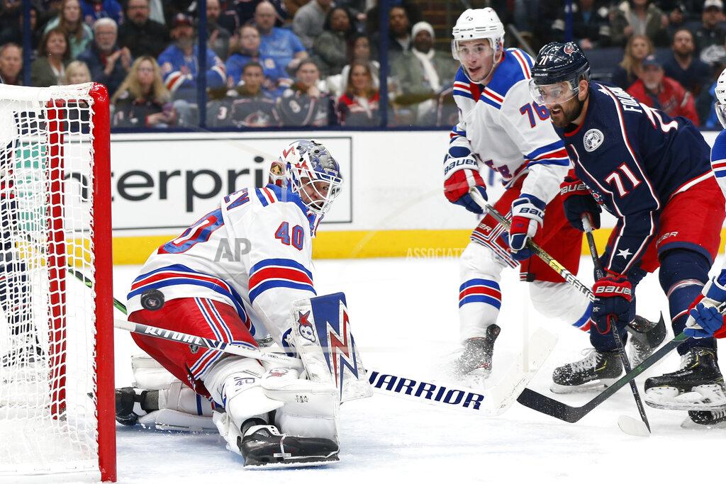 New York Rangers' Alexandar Georgiev, left, makes a save as Brady Skjei, center, and Columbus Blue Jackets' Nick Foligno watch the puck during the second period of an NHL hockey game Friday, Feb. 14, 2020, in Columbus, Ohio. (AP Photo/Jay LaPrete)