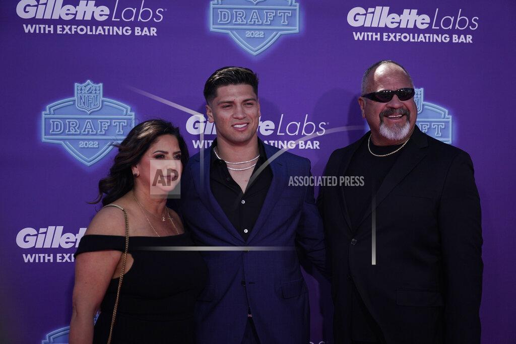 Mississippi quarterback Matt Corral poses on the red carpet with his parents Peter, right, and Liz before the first round of the NFL football draft Thursday, April 28, 2022, in Las Vegas. (AP Photo/Jae C. Hong )