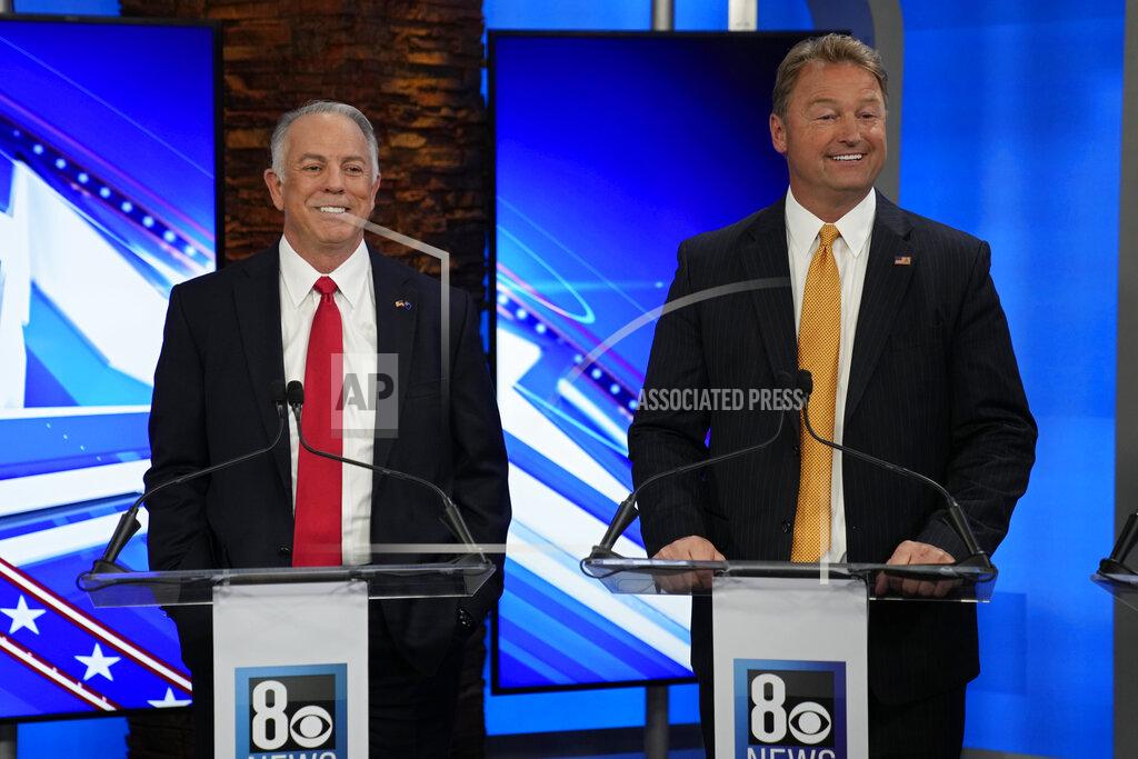John Locher Clark County Sheriff Joe Lombardo, left, and former U.S. Senator Dean Heller laugh before a Republican primary debate for Nevada governor Wednesday, May 25, 2022, in Las Vegas. (AP Photo/John Locher, Pool)