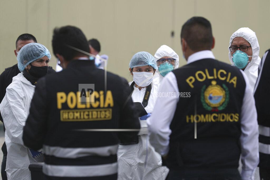 Martin Mejia Police officers and forensic investigators gather outside the Tomas Restobar disco where officials say 13 people died in a stampede after a police raid to enforce the country's lockdown during the coronavirus pandemic, Sunday, Aug. 23, 2020. The stampede happened when about 120 people that had gathered for a party on Saturday night, tried to escape through the only door of the second-floor disco, trampling one another and becoming trapped in the confined space, according to authorities. (AP Photo/Martin Mejia)