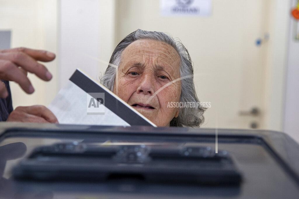 Visar Kryeziu An Albanian woman casts her vote during parliamentary elections in capital Tirana, Albania on Sunday, April 25, 2021. Albanian voters have started casting ballots in parliamentary elections on Sunday amid the virus pandemic and a bitter political rivalry between the country's two largest political parties. (AP Photo/Visar Kryeziu)