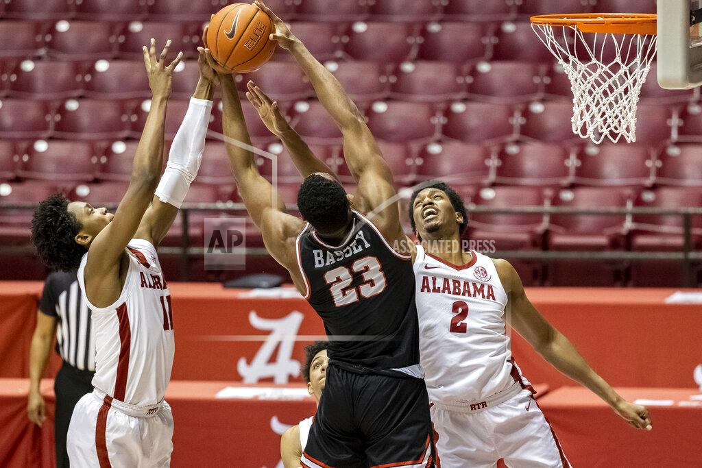 Vasha Hunt Alabama guard Joshua Primo (11) and Alabama forward Jordan Bruner (2) pressure Western Kentucky center Charles Bassey (23) as he rebounds the ball during the first half of an NCAA college basketball game, Saturday, Dec. 19, 2020, in Tuscaloosa, Ala. (AP Photo/Vasha Hunt)