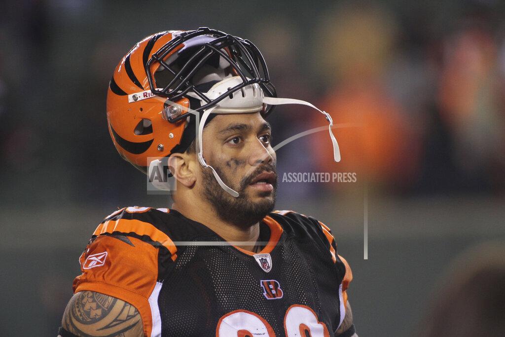 FILE - In this Jan. 1, 2012, file photo, Cincinnati Bengals defensive end Jonathan Fanene walks off the field after an NFL football game against the Baltimore Ravens in Cincinnati. Court filings allege former Cincinnati Bengals defensive end Jonathan Fanene faces charges used a pipe, golf club and broom handle to assault his wife and his sister over allegations he had an extramarital affair while on a trip to Hawaii. Fanene has been charged in the District Court of American Samoa with eight felonies, including kidnapping and assault, and five misdemeanors. He has been released on $100,000 bail and will appear in court next week. (AP Photo/Tony Tribble, File)