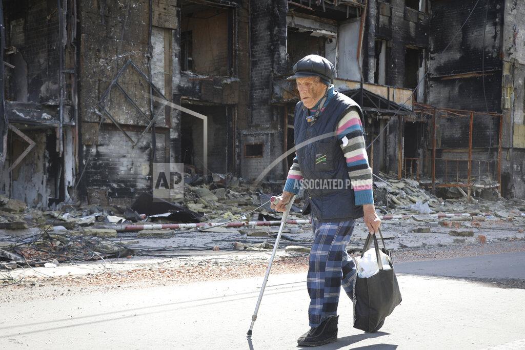 Alexei Alexandrov A resident walks past a destroyed house in Mariupol, in territory under the government of the Donetsk People's Republic, eastern Ukraine, Tuesday, May 17, 2022. (AP Photo/Alexei Alexandrov)