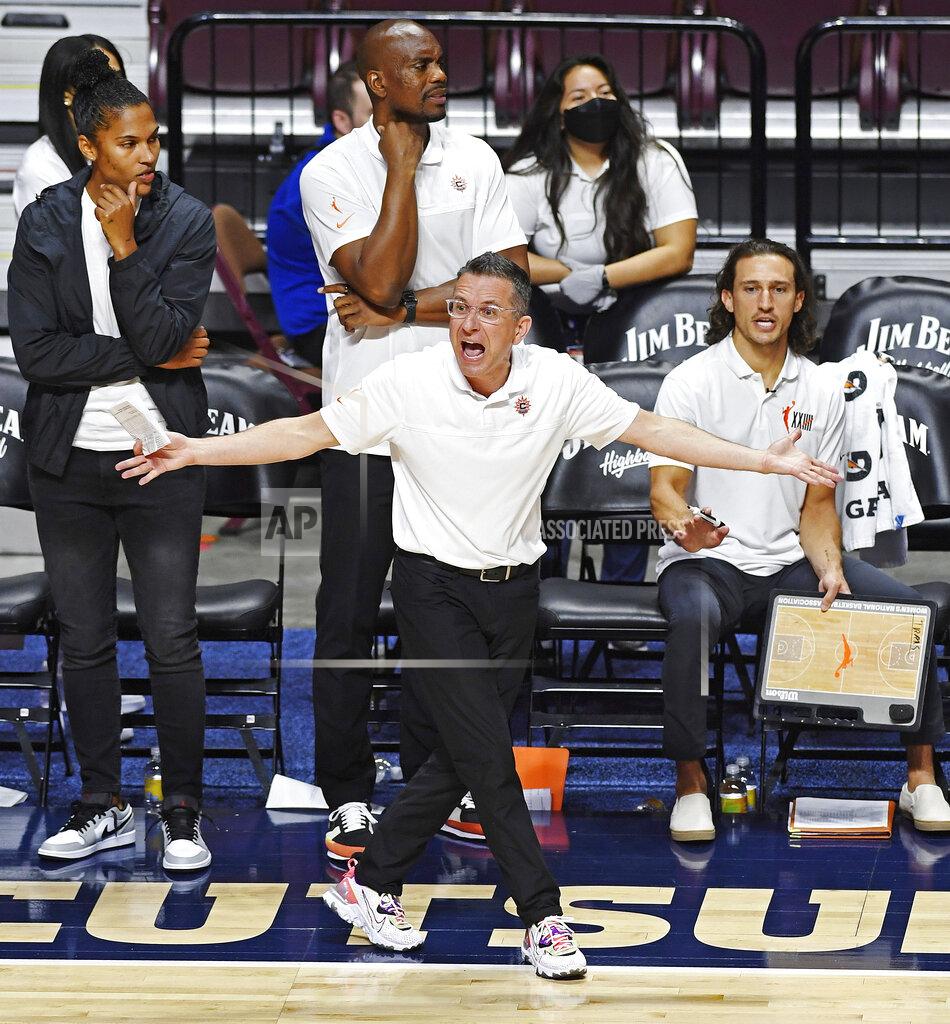 Sean D. Elliot FILE - Connecticut Sun head coach Curt Miller looks for a traveling call on an Atlanta Dream player during a WNBA basketball game in Uncasville, Conn., in this Friday, July 9, 2021, file photo. Sun coach Curt Miller was unanimously chosen as the AP's Coach of the Year, Wednesday, Sept. 22, 2021 .(Sean D. Elliot/The Day via AP, File)