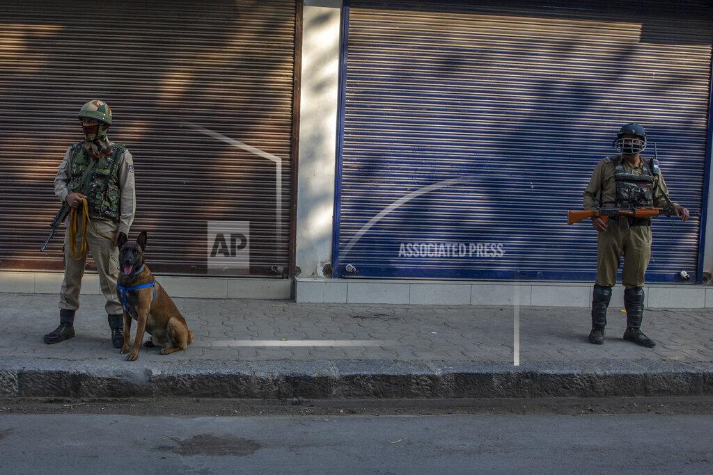Dar Yasin Paramilitary soldiers stand guard on a deserted street on the first anniversary of India’s decision to revoke the disputed region’s semi-autonomy, in Srinagar, Indian controlled Kashmir, Wednesday, Aug. 5, 2020. Last year on Aug. 5, India’s Hindu-nationalist-led government of Prime Minister Narendra Modi stripped Jammu-Kashmir of its statehood and divided it into two federally governed territories. Late Tuesday, authorities lifted a curfew in Srinagar but said restrictions on public movement, transport and commercial activities would continue because of the coronavirus pandemic. (AP Photo/ Dar Yasin)