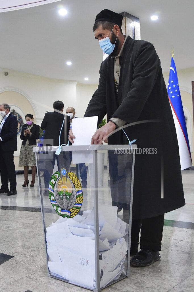 Uncredited A man casts his ballot at a polling station during the presidential election in Tashkent, Uzbekistan, Sunday, Oct. 24, 2021. Uzbeks voted Sunday in a presidential election that the incumbent is expected to win in a landslide against weak competition. Although Shavkat Mirziyoyev has relaxed many of the policies of his dictatorial predecessor, he has made little effort at political reform. He took office in 2016 upon the death of Islam Karimov and faces four relatively low-visibility candidates who did not even show up for televised debates. (AP Photo)