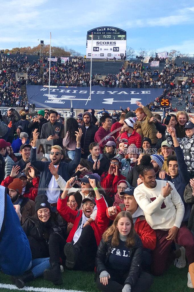 Jimmy Golen Demonstrators stage a protest on the field at the Yale Bowl disrupting the start of the second half of an NCAA college football game between Harvard and Yale, Saturday, Nov. 23, 2019, in in New Haven, Conn. (AP Photo/Jimmy Golen)
