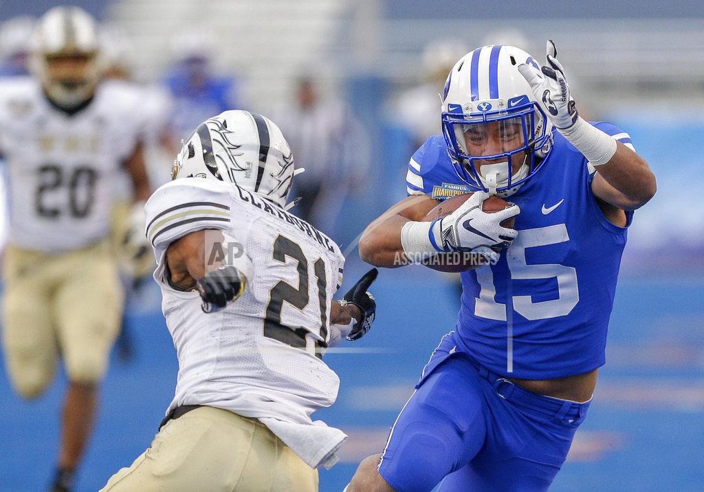 Steve Conner BYU wide receiver Aleva Hifo (15) avoids the reach of Western Michigan defensive back Stefan Claiborne (21) on a 70-yard touchdown reception in the second half of the Famous Idaho Potato Bowl NCAA college football game, Friday, Dec. 21, 2018, in Boise, Idaho. (AP Photo/Steve Conner)